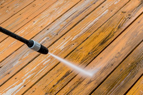 Wooden deck floor cleaning with high pressure water jet.